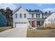 Charming two-story home with light blue siding, white trim, and a bright red front door at 1427 Homecoming Blvd, Ravenel, SC 29470