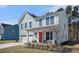 Charming two-story home with light blue siding, white trim, and a bright red front door at 1427 Homecoming Blvd, Ravenel, SC 29470