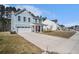 Charming two-story home with light blue siding, white trim, and a long driveway at 1427 Homecoming Blvd, Ravenel, SC 29470