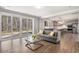 Open-concept living room with hardwood floors, a sliding door to the backyard, and a view of the kitchen at 1427 Homecoming Blvd, Ravenel, SC 29470