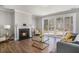 Cozy living room with a fireplace, hardwood floors, and a sliding door to the backyard at 1427 Homecoming Blvd, Ravenel, SC 29470