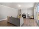Cozy living room with a fireplace, hardwood floors, and a sliding door to the backyard at 1427 Homecoming Blvd, Ravenel, SC 29470