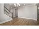 Bright, open-concept living space features hardwood floors, modern lighting, and staircase at 1427 Homecoming Blvd, Ravenel, SC 29470