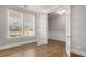 The home office features a stunning glass door, bright windows, and hardwood floors at 1427 Homecoming Blvd, Ravenel, SC 29470