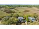 Breathtaking aerial view of a brick home with mature trees and scenic marsh views at 1521 Hurtes Island Dr, Charleston, SC 29407