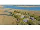 Captivating aerial view showcases waterfront homes with private docks nestled among lush greenery along marsh waterways at 1521 Hurtes Island Dr, Charleston, SC 29407