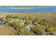 Aerial view showcasing homes among trees and marshland with waterfront access, providing scenic and secluded living at 1521 Hurtes Island Dr, Charleston, SC 29407