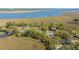 Aerial view of homes nestled among trees along marsh waterways, offering scenic views and waterfront access at 1521 Hurtes Island Dr, Charleston, SC 29407
