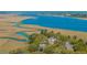 Aerial view of homes nestled amongst trees and overlooking the marsh and river at 1521 Hurtes Island Dr, Charleston, SC 29407