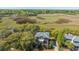 Stunning aerial perspective of the brick home surrounded by lush greenery and picturesque marshland at 1521 Hurtes Island Dr, Charleston, SC 29407