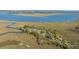 Picturesque aerial view of residences nestled in greenery by marshlands and waterfront, offering a peaceful coastal lifestyle at 1521 Hurtes Island Dr, Charleston, SC 29407