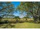 Expansive backyard with lush lawn, mature trees and scenic views of the marsh at 1521 Hurtes Island Dr, Charleston, SC 29407