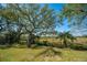 Expansive backyard with mature trees and lush marsh views providing a tranquil setting at 1521 Hurtes Island Dr, Charleston, SC 29407
