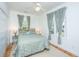 Charming bedroom with large windows, ceiling fan, and hardwood floors at 1521 Hurtes Island Dr, Charleston, SC 29407
