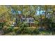 Charming brick home with a screened porch, situated among mature trees and lush landscaping at 1521 Hurtes Island Dr, Charleston, SC 29407