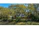 Charming brick home featuring a screened porch and lush landscaping, nestled amongst mature trees at 1521 Hurtes Island Dr, Charleston, SC 29407