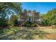 Charming two-story brick home boasts mature landscaping and a welcoming front porch at 1521 Hurtes Island Dr, Charleston, SC 29407