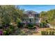Aerial view of a two-story brick home with manicured lawn and mature trees at 1521 Hurtes Island Dr, Charleston, SC 29407
