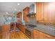 Well-equipped kitchen featuring wooden cabinets, granite counters, and stainless steel appliances at 1521 Hurtes Island Dr, Charleston, SC 29407
