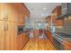 Modern kitchen with stainless steel appliances, wood cabinetry, and hardwood floors at 1521 Hurtes Island Dr, Charleston, SC 29407