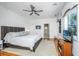 Spacious main bedroom featuring hardwood floors, TV, windows, ceiling fan and a sitting area at 1521 Hurtes Island Dr, Charleston, SC 29407