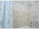 Shower area featuring neutral tile, a shower curtain and modern fixtures at 1521 Hurtes Island Dr, Charleston, SC 29407