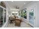 Cozy sunroom featuring wicker seating, brick walls, ceiling fan, and outdoor access at 1521 Hurtes Island Dr, Charleston, SC 29407