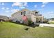 View of backyard with an American flag, well-manicured lawn and fence at 158 Woodland Oak Way, Summerville, SC 29485