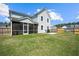 Spacious backyard featuring a screened-in porch, patio with seating, and a privacy fence at 158 Woodland Oak Way, Summerville, SC 29485