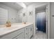 Bathroom featuring double sinks with brushed gold faucets, framed mirror and modern cabinetry at 158 Woodland Oak Way, Summerville, SC 29485