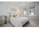 Cozy bedroom featuring decorative wallpaper, plush bedding, and natural light at 158 Woodland Oak Way, Summerville, SC 29485