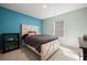 Cozy bedroom with a rustic wood bed frame, soft carpeting, and a bright window view at 158 Woodland Oak Way, Summerville, SC 29485