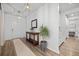 Bright entryway featuring wood floors, console table, mirror, and a plant at 158 Woodland Oak Way, Summerville, SC 29485