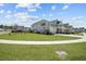 Inviting two-story home with manicured lawn, sidewalk and an American flag at 158 Woodland Oak Way, Summerville, SC 29485