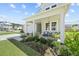 Inviting front porch with comfortable seating, lush landscaping, and charming curb appeal at 158 Woodland Oak Way, Summerville, SC 29485
