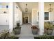 Inviting front porch with pendant lighting and decorative plants at 158 Woodland Oak Way, Summerville, SC 29485