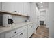 Hallway with storage cabinets leads to a bright office space with a desk at 158 Woodland Oak Way, Summerville, SC 29485