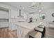 Kitchen island featuring a white countertop, white cabinets, modern faucet and bar stool seating at 158 Woodland Oak Way, Summerville, SC 29485