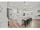Modern kitchen featuring white cabinets, stainless steel appliances, a central island with seating, and stylish pendant lighting at 158 Woodland Oak Way, Summerville, SC 29485