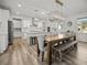 Spacious kitchen featuring white cabinets, a large island, and modern lighting fixtures at 158 Woodland Oak Way, Summerville, SC 29485
