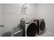 Modern laundry room with front-loading washer and dryer and wire shelving above at 158 Woodland Oak Way, Summerville, SC 29485