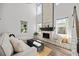 Bright living room boasts a soaring two-story ceiling, a stunning brick fireplace, and abundant natural light at 158 Woodland Oak Way, Summerville, SC 29485