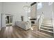 Bright living room featuring hardwood floors, a stone fireplace, and a modern chandelier at 158 Woodland Oak Way, Summerville, SC 29485