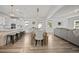 Open-concept living space featuring a dining area, kitchen, and living room with hardwood floors at 158 Woodland Oak Way, Summerville, SC 29485