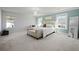 Comfortable main bedroom featuring stylish light fixture, neutral tones, bench, accent wall and an abundance of light at 158 Woodland Oak Way, Summerville, SC 29485