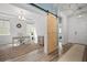 Bright office space with a modern sliding barn door, hardwood floors, and ample natural light at 158 Woodland Oak Way, Summerville, SC 29485