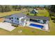 Stunning aerial view of a sprawling white farmhouse with a pool and lush green lawn at 161 Ryefield Ln, Ridgeville, SC 29472