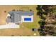An overhead view of a home boasting a modern pool, meticulously kept grounds, and a surrounding forest at 161 Ryefield Ln, Ridgeville, SC 29472