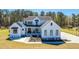 Stunning aerial view of a two-story white home with well-manicured landscaping and lush greenery at 161 Ryefield Ln, Ridgeville, SC 29472
