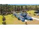 Aerial shot of a white two-story home with a pool, manicured yard, and tall surrounding trees at 161 Ryefield Ln, Ridgeville, SC 29472